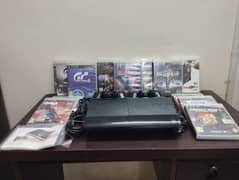 PS 3 Super Slim 500 GB with 2 remote controls and 12 games for sale.