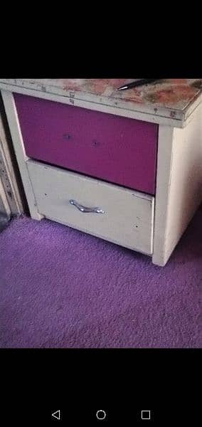 two single beds and side table pink and creame colour