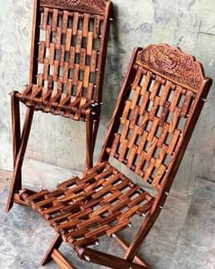pair of 2 wooden relaxing chairs with 1 table