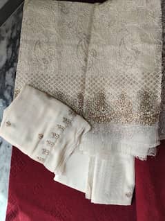 Off white khaadi net embroided dress.
