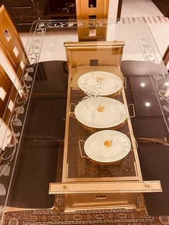 Eight chairs, big dining table, gold, and black team theme