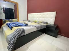 king size bed in good condition white and black theme .