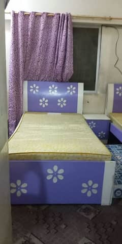 2 single beds with 1side table with mattress.