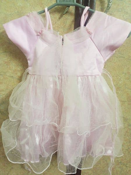 baby girl fancy frock in baby pink colour 1