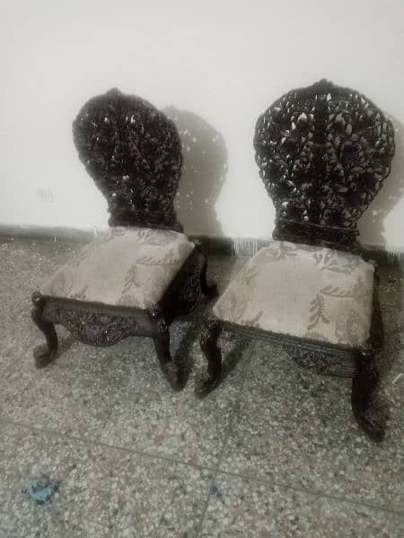 two saithian chairs with one middle table 1