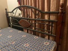 used rodiron king-sized bed with mattress