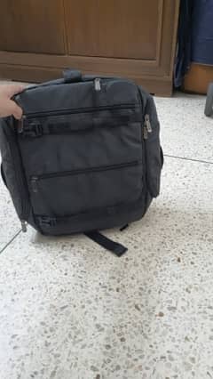 black bag with lots of pockets and back opening