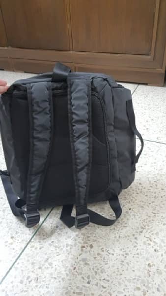 black bag with lots of pockets and back opening 1