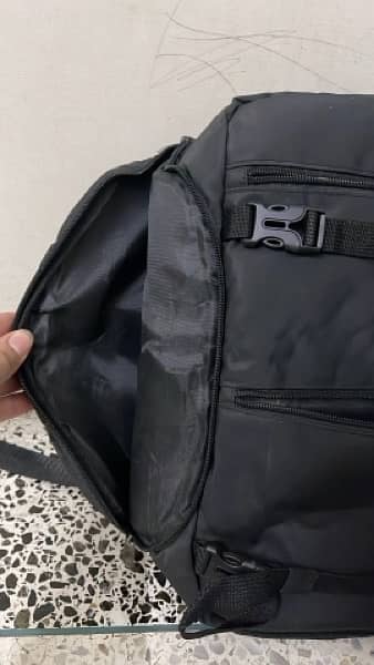 black bag with lots of pockets and back opening 2