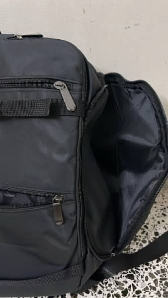 black bag with lots of pockets and back opening 3