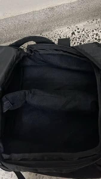 black bag with lots of pockets and back opening 4