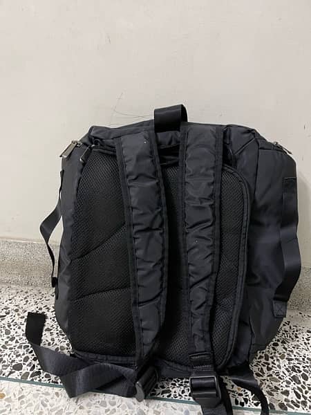 black bag with lots of pockets and back opening 5