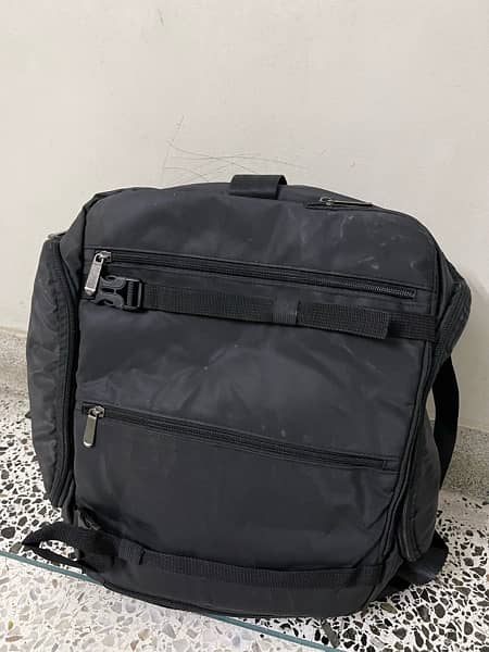 black bag with lots of pockets and back opening 6