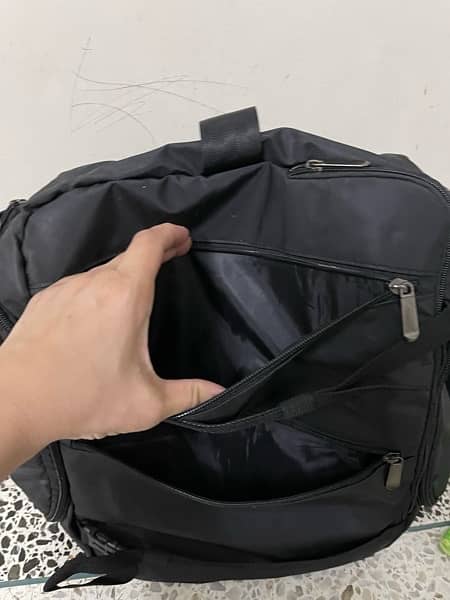 black bag with lots of pockets and back opening 7