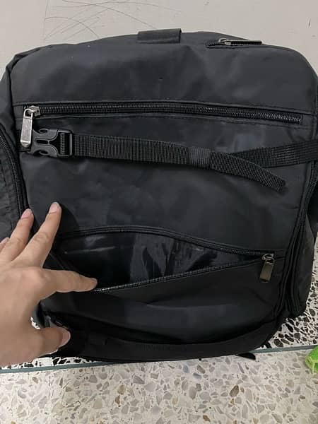 black bag with lots of pockets and back opening 8