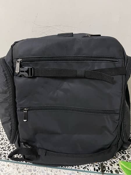 black bag with lots of pockets and back opening 9