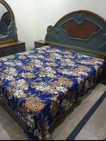 A wooden bed and dressing with side tables 0