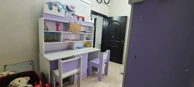Kids large study table, two chairs and attached cupboard and storage 0