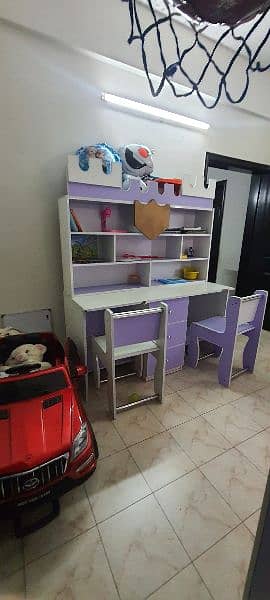 Kids large study table, two chairs and attached cupboard and storage 1