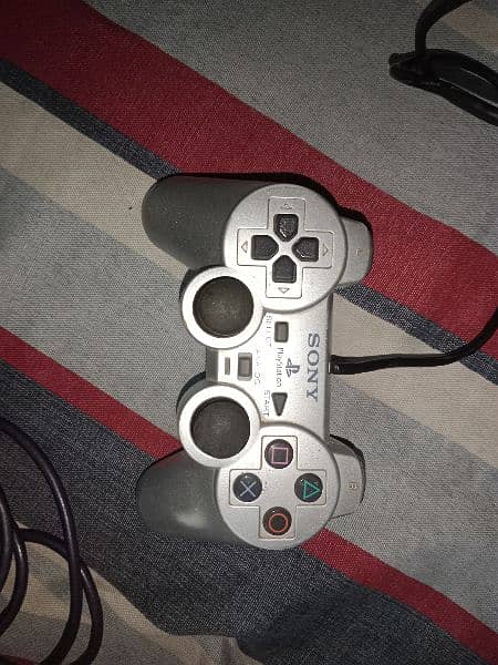 PlayStation 2 controller and one madcatz controller 0
