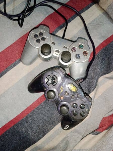 PlayStation 2 controller and one madcatz controller 1