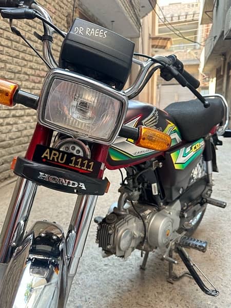 honda 70 with golden number ARU 1111 3