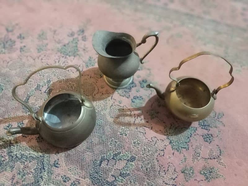2 Antique tea pots and 1 water pitcher, made of brass 1
