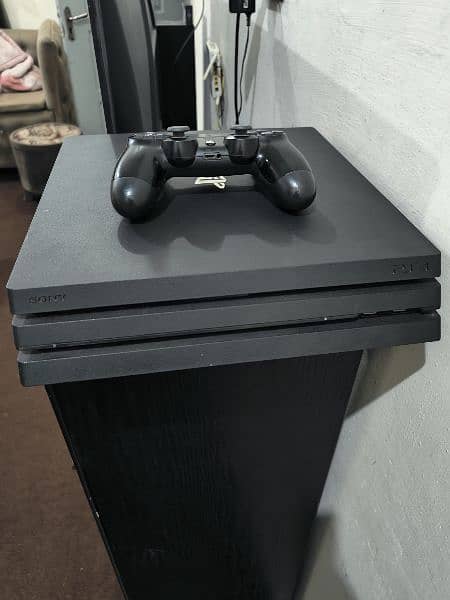 ps4 pro 1 tb with some games 10/10 condition 1