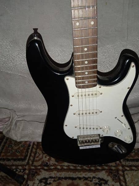 Electric guitar with stand and cable 2