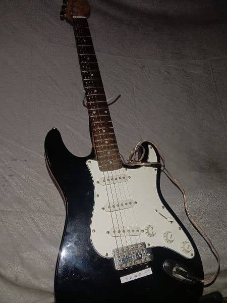 Electric guitar with stand and cable 4
