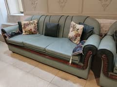 3, 2 ,1 seater sofa with dull green leather covering.