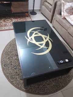 black centre table with attractive golden motif in good condition