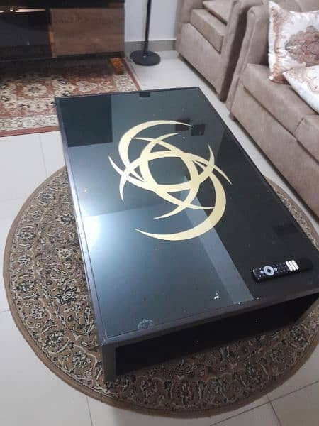 black centre table with attractive golden motif in good condition 0