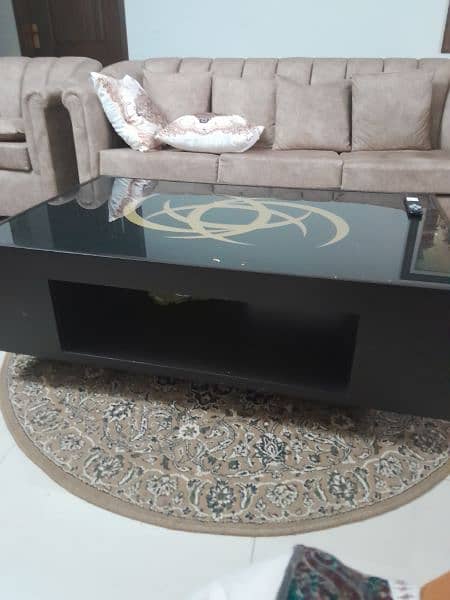 black centre table with attractive golden motif in good condition 1