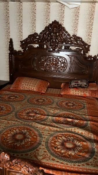 King size bed with wooden chairs set and table 0
