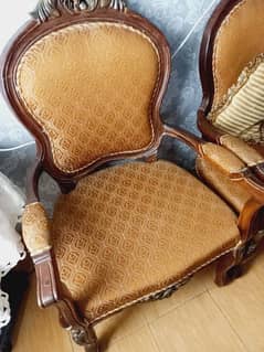 pair of wood coffee chairs with centre table