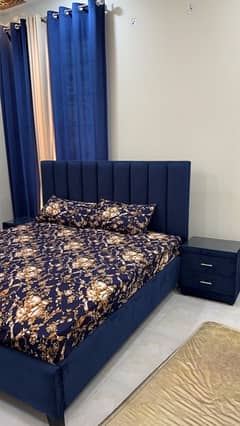 tufted blue velvet bed with side tables