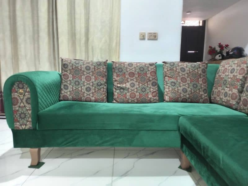 l shaped sofa in green color with cushions 1