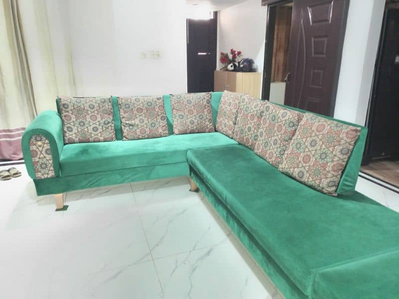 l shaped sofa in green color with cushions 2