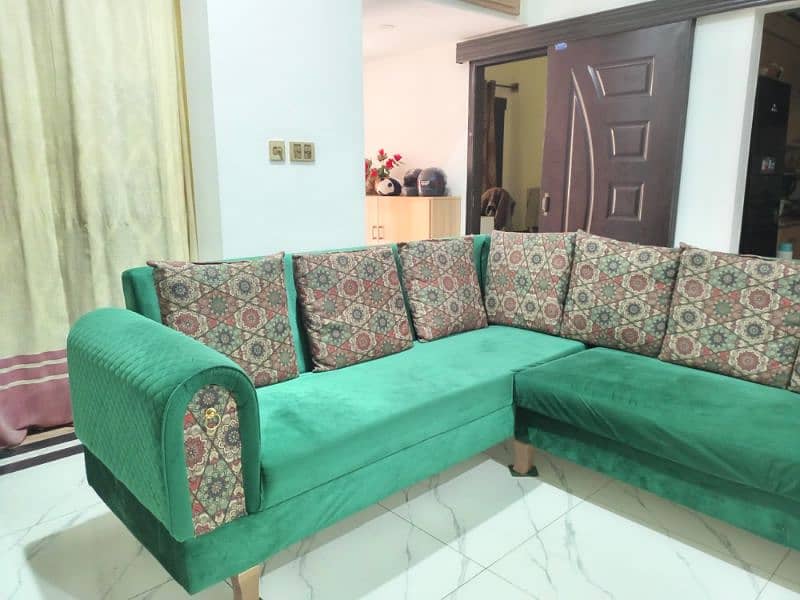 l shaped sofa in green color with cushions 4