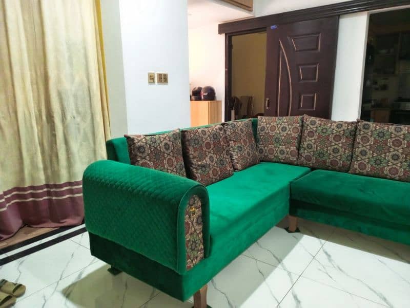 l shaped sofa in green color with cushions 9