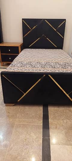 single bed with mattress and single side table