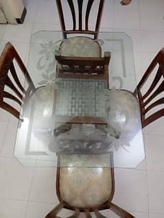 Glass top dinning table with four chairs
