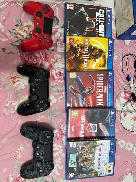 Sony Play Station 4 with games and three controllers 2
