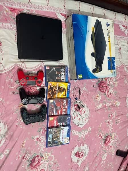 Sony Play Station 4 with games and three controllers 8