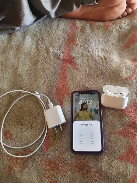 iphone 12 pro with earbuds and charger 3