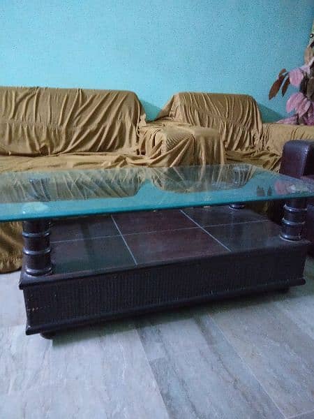 wooden table with glass on top 0