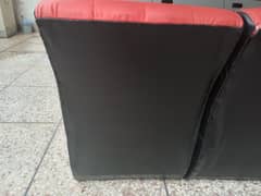 Used sofa in red and black color. Leather polish. 0