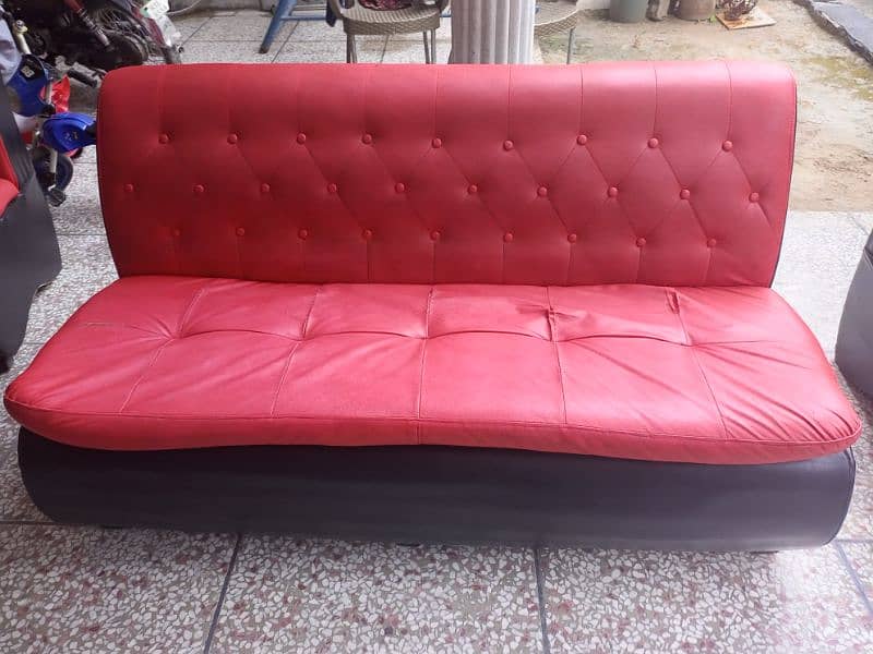 Used sofa in red and black color. Leather polish. 6