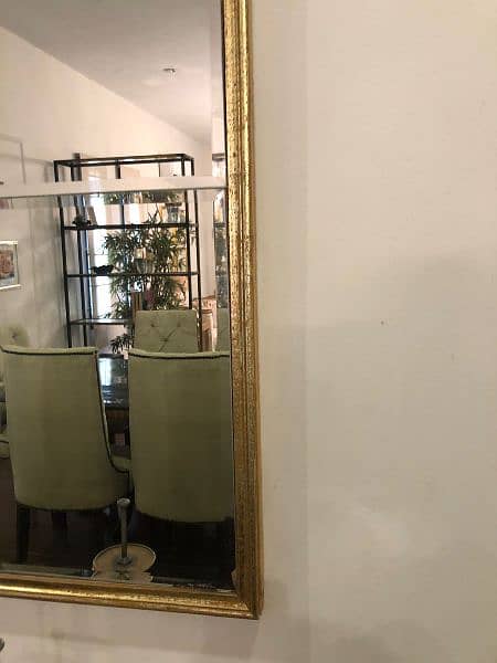 golden brass mirror and beige and golden cushioned seats 4